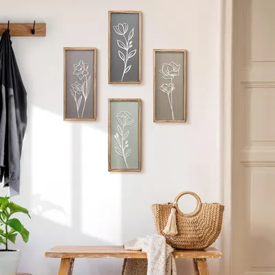 Demonstrates how the framed floral art pieces look when styled in a real home environment, helping shoppers visualize the product in their own space.