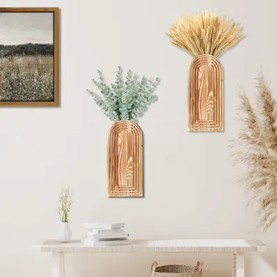 Demonstrates how the wall-mounted vases look when styled in a real home environment to help shoppers visualize the product in their own space.