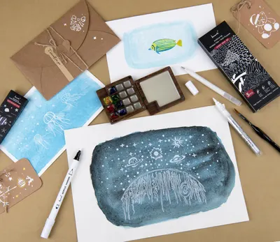 Shows everything included in the art kit to help shoppers understand the full value and contents they will receive, including paints, brushes, stencils, envelopes, and finished artwork examples.