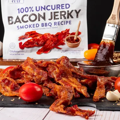 Showcases the bacon jerky in an appetizing, real-world culinary setting to help shoppers visualize the product's taste appeal and usage context.