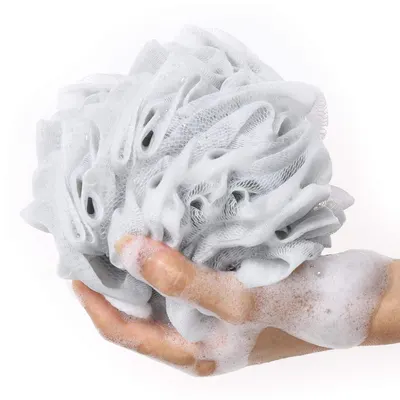 Demonstrates the product in real-world use with hands holding the lathered loofah, showing shoppers how the product performs and creates rich foam during bathing.
