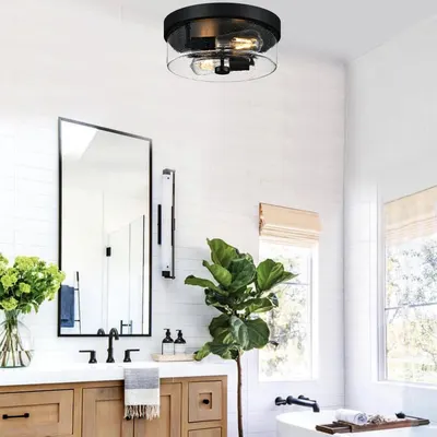 Showcases the product installed in a real-world bathroom environment to help shoppers visualize how the light fixture will look in their own home.