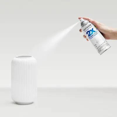 Demonstrates the product being used in a real-world setting to help shoppers visualize how they would use the spray paint on home decor items.