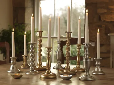 Showcases the candle holders in an elegant, real-world home setting to help shoppers visualize how the product collection would look styled in their own space.