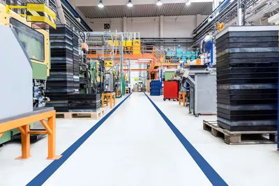 Shows the product in a real-world industrial/manufacturing setting to demonstrate its professional application and scale of operations.