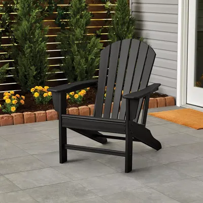 Showcases the product in a real-world outdoor patio setting to help shoppers visualize how the chair would look and fit in their own outdoor space.