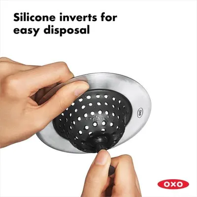 Demonstrates how the silicone drain cover inverts for easy disposal of trapped debris, highlighting the product's ease of use and cleaning convenience. Communicates the key benefit of easy disposal…