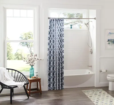 Showcases the product (shower curtain) in a real-world bathroom environment to help shoppers visualize how it looks in their own home and fits with their decor style.