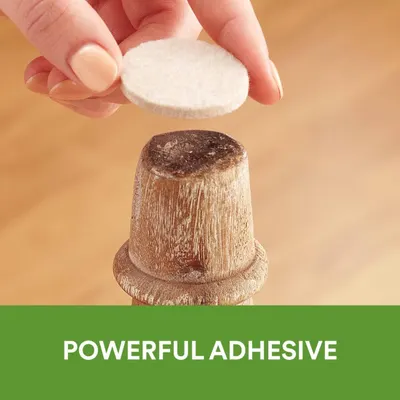 Demonstrates the product's strong adhesive capability by showing a hand holding a pad above a wooden surface, reassuring shoppers that the product will stick securely.