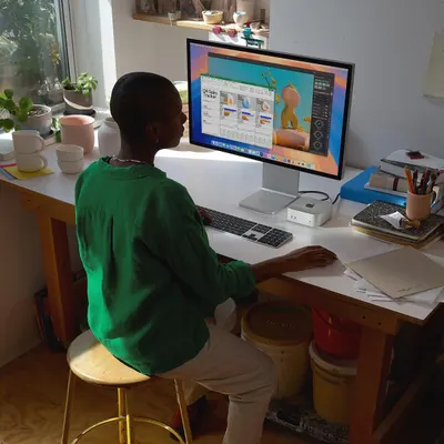 Demonstrates the product in a real-world home office environment to help shoppers visualize how it fits into their daily creative workflow and lifestyle.