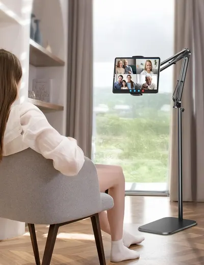 Demonstrates the product in a real-world home setting during a video call, showing how the adjustable stand enables comfortable, hands-free video conferencing with family or friends.