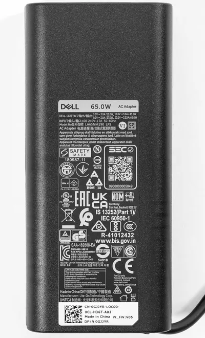 Provides a clean, catalog-style view of the Dell AC adapter showing the product label and certifications for shopper reference.