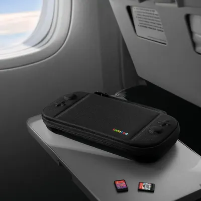 Demonstrates the product in a real-world travel context (airplane tray table) to show its portability and suitability for on-the-go use.