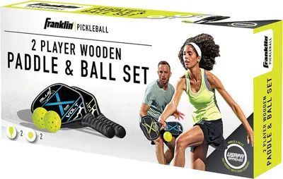 Shows shoppers everything included in the package: two wooden paddles and two balls, making it clear this is a complete ready-to-play set for two players.