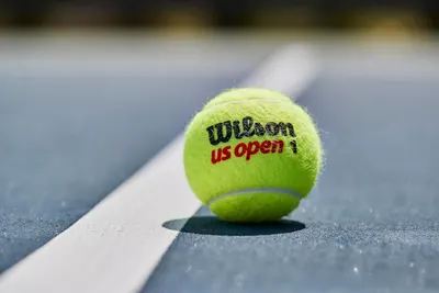 Shows the product in its real-world context on a tennis court to help shoppers visualize the product in action and connect with the sport.