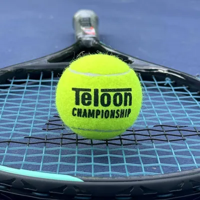 Showcases the product in a real-world tennis environment to help shoppers visualize the ball in action and connect with the sport context.