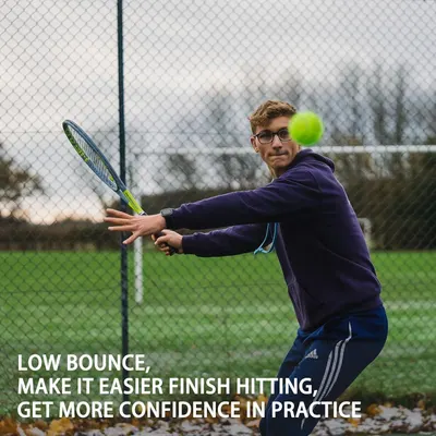 Communicates that the tennis ball's low bounce characteristic makes it easier to hit and helps build confidence during practice, appealing to beginners or those improving their game.