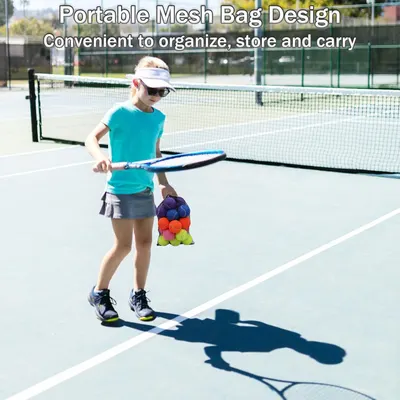 Demonstrates the mesh bag's portability and convenience for organizing and carrying sports equipment, shown in a real-world tennis court setting.