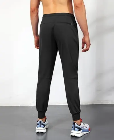 Displays the back view of the jogger pants on a model to show fit, silhouette, and design details from the rear angle.
