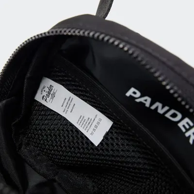 Shows the interior construction and branding details of the product, highlighting the quality label and zipper mechanism to communicate craftsmanship and authenticity.