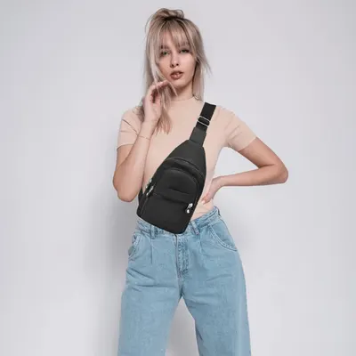 Demonstrates how the crossbody sling bag looks when worn in a casual, everyday lifestyle context to help shoppers visualize the product in use.