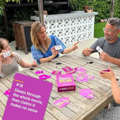 Demonstrates the product being enjoyed by a family in a natural outdoor setting, showing the social and entertainment value of the card game.