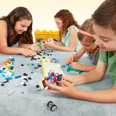 Shows children enjoying the product together in a real-world play setting, helping shoppers visualize the product being used by multiple kids in a home environment.
