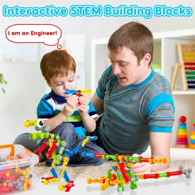 Shows the product being used in a real-world home setting with a parent and child engaged in creative STEM play, demonstrating the interactive and educational nature of the building blocks.