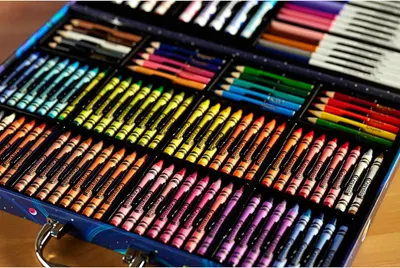 Shows the customer everything included in the art kit — colored pencils, crayons, markers, and other art supplies — to demonstrate the comprehensive value and variety of the bundle.