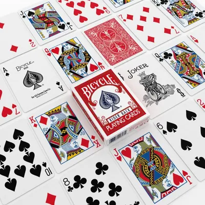 Shows the customer everything included in the purchase: the full deck of playing cards, the box, and all card types (face cards, number cards, joker) to demonstrate the complete product contents.