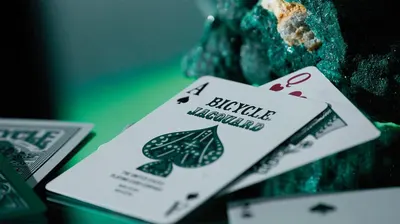 Creates an artistic, lifestyle mood showcasing the playing cards in a visually appealing environment to evoke quality and aesthetic appeal.