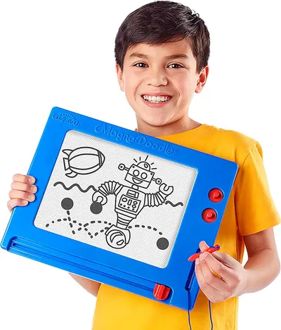 Shows a child actively using the magnetic drawing board in a real-world context to help shoppers visualize the product in action and understand its appeal for kids.