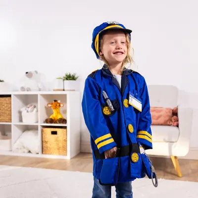 Shows the product being worn by a child in a real home environment to help shoppers visualize the costume in use and assess fit and appearance.