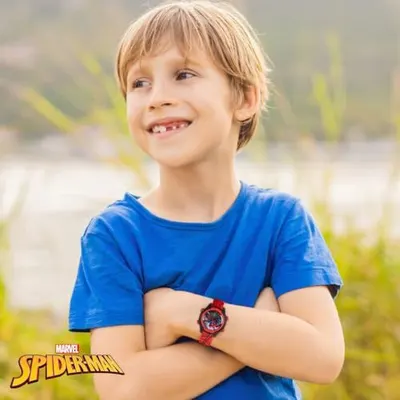 Demonstrates the product (Spider-Man watch) being worn by a child in a natural, real-world setting to help shoppers visualize the product in use and appeal to the target audience.