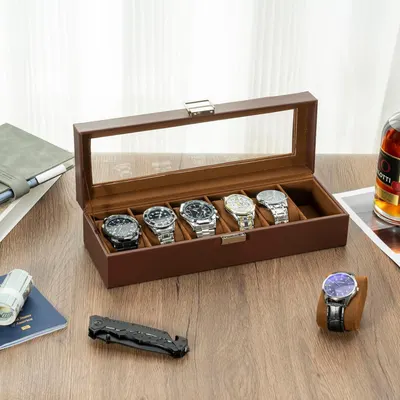 Showcases the product in a real-world lifestyle setting to help shoppers visualize how the watch case organizes and displays their collection in an elegant home or office environment.