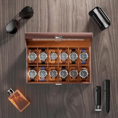 Shows the complete package the customer receives, including the watch display case, multiple watches with interchangeable bands, and complementary lifestyle accessories like sunglasses, cologne, and…