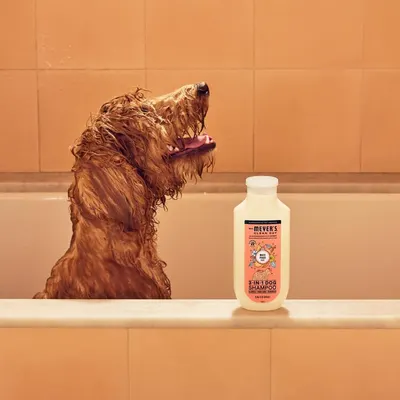 Shows the product in a real-world bathroom setting with a dog during bath time to help shoppers visualize the product in use and create an emotional connection.