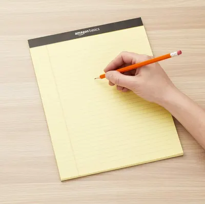 Shows the notepad being used in a real-world office or home setting to help shoppers visualize the product in everyday use.