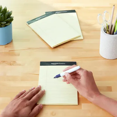 Shows the product in a natural, everyday setting to help shoppers visualize how the notepads fit into their workspace or daily routine.