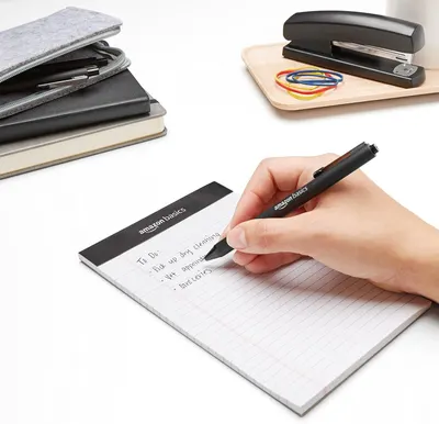 Demonstrates the product in a real-world office setting to help shoppers visualize how the AmazonBasics stationery items fit into their daily work routine.