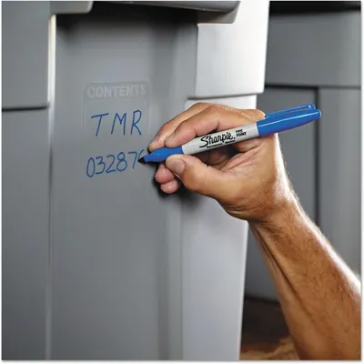 Demonstrates the marker being used in a real-world context to label storage containers, showing practical everyday application without text overlay or feature callouts.
