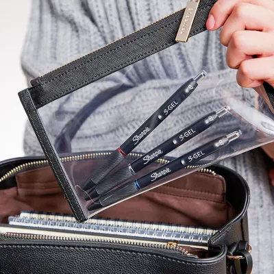 Shows the customer what's included in the purchase: three Sharpie S-Gel pens in a clear protective case, demonstrating the complete kit and its organization.