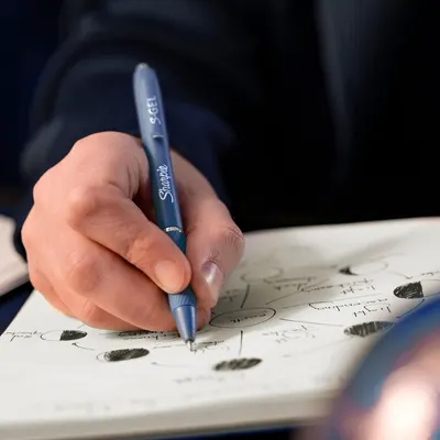 Shows the product being used in a real-world setting to help shoppers visualize how they would use the pen in their daily life.