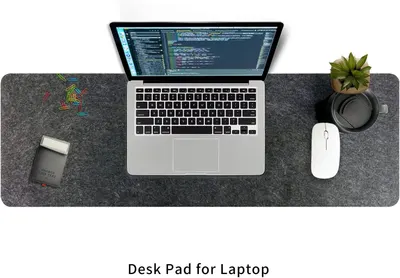 Demonstrates the product in a real-world workspace setting, showing how the desk pad fits naturally into a professional environment with a laptop, mouse, and office accessories.