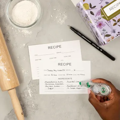Demonstrates the product (recipe cards) in a real-world baking context to help shoppers visualize how they would use the cards in their own kitchen.