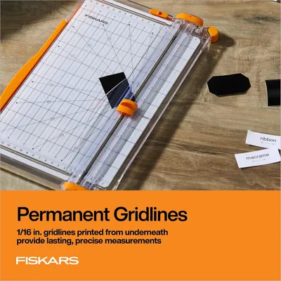 Highlights the paper trimmer's permanent 1/16 inch gridlines printed from underneath, emphasizing precision and durability for accurate cutting measurements.
