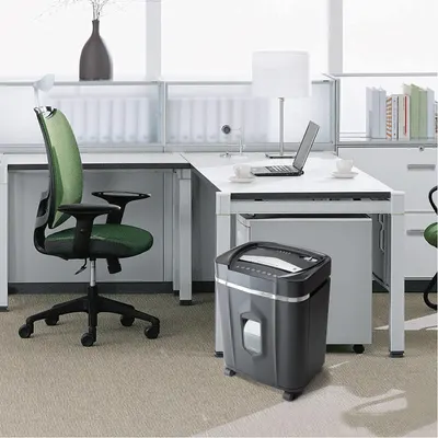 Demonstrates the product in a real-world office setting to help shoppers visualize how the paper shredder fits naturally into their workspace.