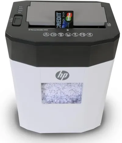 Provides a clean, catalog-style product image showing the HP Microcut Shredder with visible shredded paper in the bin, allowing shoppers to see the product clearly without distractions.