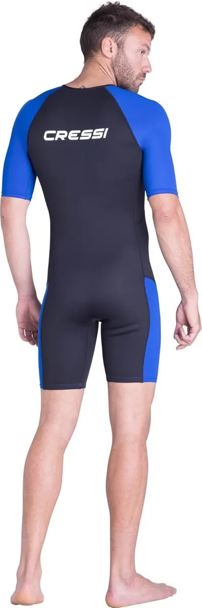 Displays the product worn on a model from the back to show fit, design, color blocking, and brand logo placement on a clean white background.