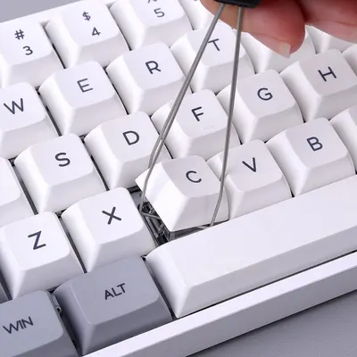 Demonstrates the keyboard's hot-swappable key feature, showing users they can easily remove and replace keys without tools for customization or maintenance.